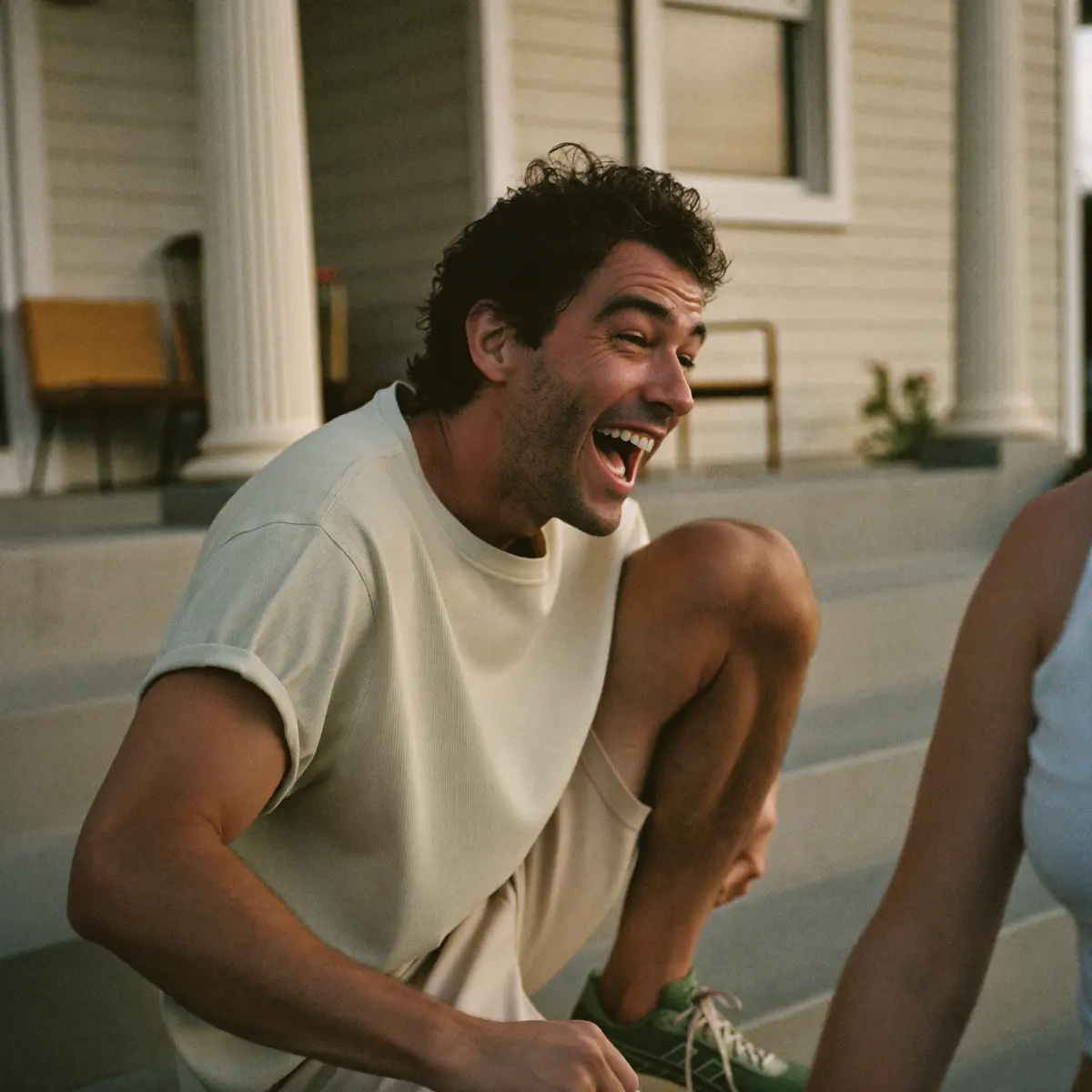 Man laughing while tying his running shoes