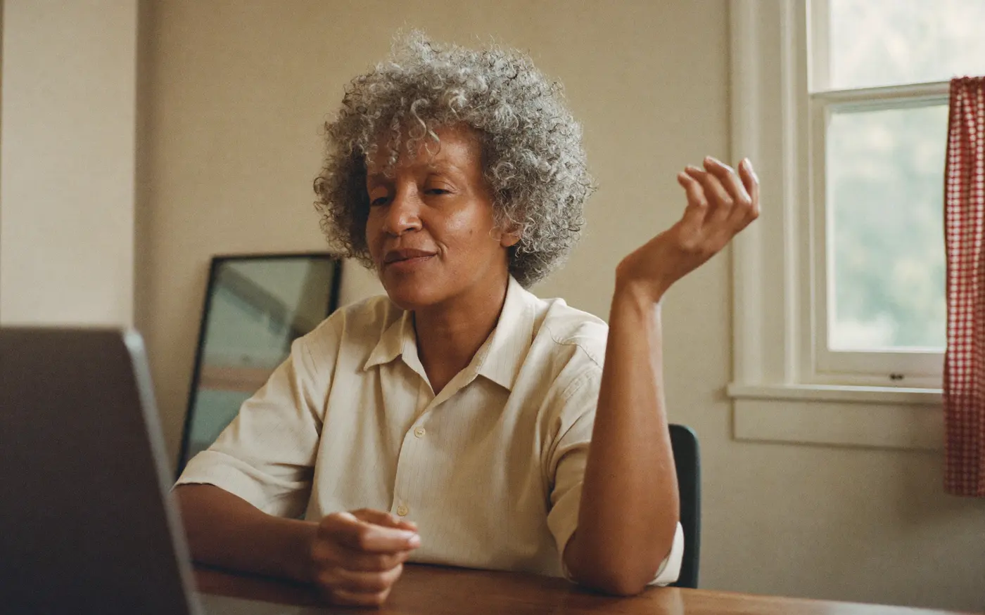 Woman on a video call at her kitchen table