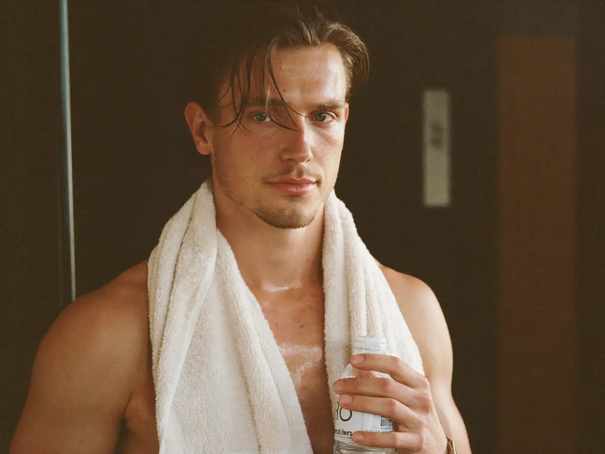 Man with a towel around his neck after a workout